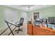 Well-lit home office featuring a spacious desk, comfortable chair, and closet for optimal organization at 122 Long Cove Ln, Mooresville, NC 28117