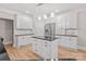 Well-lit kitchen featuring white cabinetry, stainless steel appliances, and a center island at 122 Long Cove Ln, Mooresville, NC 28117