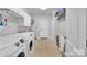 Well-equipped laundry room with modern appliances and storage, offering convenience at 122 Long Cove Ln, Mooresville, NC 28117