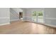 Spacious living room featuring wood floors, neutral walls and plenty of natural light at 122 Long Cove Ln, Mooresville, NC 28117