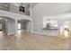 Open-concept living room with high ceilings, hardwood floors, and an abundance of natural light at 122 Long Cove Ln, Mooresville, NC 28117