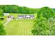 Expansive lawn and picturesque home nestled among lush green trees at 1238 Shinnville Rd, Cleveland, NC 27013