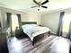 Spacious bedroom with gray wood floors, crown molding, and a large window at 1238 Shinnville Rd, Cleveland, NC 27013