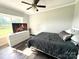 A neutral bedroom featuring a ceiling fan, wood-look floors, and a television for a cozy feel at 1238 Shinnville Rd, Cleveland, NC 27013
