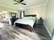 Comfortable bedroom with gray wood floors, ceiling fan, and neutral gray walls at 1238 Shinnville Rd, Cleveland, NC 27013
