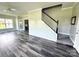 Inviting entryway featuring gray wood floors, black and white stairs, and neutral paint at 1238 Shinnville Rd, Cleveland, NC 27013