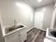 Well-lit laundry room with a stainless steel utility sink and modern appliances for efficient chores at 1238 Shinnville Rd, Cleveland, NC 27013
