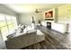 Bright living room with a large sectional sofa, fireplace, and a view of the front yard at 1238 Shinnville Rd, Cleveland, NC 27013