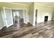 Living room featuring a fireplace, French doors, and wood-look flooring at 1238 Shinnville Rd, Cleveland, NC 27013
