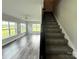 Living room featuring a staircase, lots of windows, and wood-look flooring at 1238 Shinnville Rd, Cleveland, NC 27013