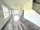Bright, open living room with gray wood floors and lots of natural light from large windows at 1238 Shinnville Rd, Cleveland, NC 27013