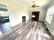 Living room with a fireplace, lots of natural light, and wood-look flooring at 1238 Shinnville Rd, Cleveland, NC 27013