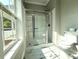 Well-lit bathroom with glass-enclosed shower and marble tile flooring at 1238 Shinnville Rd, Cleveland, NC 27013