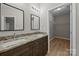 Bathroom featuring double sink vanity with granite countertop and a walk-in closet at 126 Aurora Blvd, Matthews, NC 28105