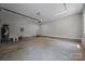 Spacious two-car garage with utilities, gray walls and concrete floor for parking or storage at 126 Aurora Blvd, Matthews, NC 28105