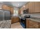 Modern kitchen with granite counters, stainless steel appliances, and wood-look flooring at 126 Aurora Blvd, Matthews, NC 28105