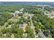 Expansive aerial view of a neighborhood, showcasing lush greenery and residential streets at 130 Aurora Blvd, Matthews, NC 28105