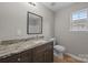 Bathroom with a granite vanity, toilet, and tile shower at 130 Aurora Blvd, Matthews, NC 28105