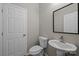 Powder room with a pedestal sink, mirror and toilet at 130 Aurora Blvd, Matthews, NC 28105