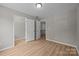 Spacious bedroom featuring wood-look flooring, neutral walls, closet, and natural light at 130 Aurora Blvd, Matthews, NC 28105