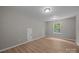 Inviting bedroom boasting modern wood-look floors and a sunlit window at 130 Aurora Blvd, Matthews, NC 28105