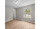 Bedroom features wood-look flooring, natural light, and an interior door at 130 Aurora Blvd, Matthews, NC 28105