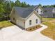 New construction home boasts a large driveway leading to a two-car garage at 130 Aurora Blvd, Matthews, NC 28105