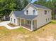 New construction home boasts a lush yard and covered front porch at 130 Aurora Blvd, Matthews, NC 28105