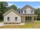Charming new construction home features a welcoming front porch and a well-manicured lawn at 130 Aurora Blvd, Matthews, NC 28105