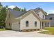 View of the side of the home featuring a 2-car garage and nice landscaping at 130 Aurora Blvd, Matthews, NC 28105