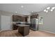 An open kitchen features an island, stainless steel appliances, wood cabinets, and granite countertops at 130 Aurora Blvd, Matthews, NC 28105