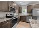 Modern kitchen features stainless steel appliances, wood cabinets and granite countertops at 130 Aurora Blvd, Matthews, NC 28105