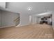 Unfurnished living area with light wood flooring and staircase to the second floor at 130 Aurora Blvd, Matthews, NC 28105