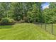 Extensive backyard featuring a lush lawn and a stately perimeter fence at 1310 Weddington Hills Dr, Matthews, NC 28104