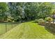 Expansive, well-maintained backyard with lush lawn and privacy fence, perfect for Gathering enjoyment at 1310 Weddington Hills Dr, Matthews, NC 28104