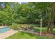 Cozy outdoor seating area with fire pit, surrounded by lush greenery and landscaping at 1310 Weddington Hills Dr, Matthews, NC 28104
