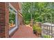Outdoor brick patio with lush greenery and plantings, brick railing, providing private space for relaxation at 1310 Weddington Hills Dr, Matthews, NC 28104