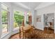 Cozy dining area with wooden table set, bathed in natural light and offering charming outdoor views at 1310 Weddington Hills Dr, Matthews, NC 28104