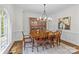 Formal dining room with chandelier, large table, ten chairs, hutch, and lots of natural light at 1310 Weddington Hills Dr, Matthews, NC 28104