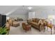 Cozy living room features neutral tones, complemented by a plush couch, woven armchair, and soft, patterned carpeting at 1310 Weddington Hills Dr, Matthews, NC 28104