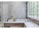 Beautiful bathroom featuring a deep soaking tub, marble countertops, and a glass block window at 1310 Weddington Hills Dr, Matthews, NC 28104