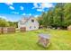 Large, fenced backyard with a garden, playhouse, and ample space for outdoor activities at 132 Witherspoon Ln, Statesville, NC 28677