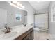 Bathroom featuring double sink vanity with bronze fixtures, large mirror, stylish lighting, and tile flooring at 132 Witherspoon Ln, Statesville, NC 28677