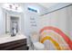 Bright bathroom featuring a modern vanity, stylish mirror, and colorful shower curtain at 132 Witherspoon Ln, Statesville, NC 28677