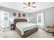 Cozy bedroom featuring neutral walls, carpet, ceiling fan, a picture window, and comfy rocking chair at 132 Witherspoon Ln, Statesville, NC 28677