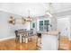 Open-concept dining area with hardwood floors, a dining table and a view of the well-equipped kitchen at 132 Witherspoon Ln, Statesville, NC 28677