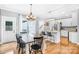 Open-concept dining area featuring a dining table and a view of the kitchen and the outdoor space at 132 Witherspoon Ln, Statesville, NC 28677