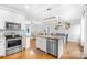 Open concept kitchen features stainless steel appliances, granite countertops, island with seating, and eat-in dining area at 132 Witherspoon Ln, Statesville, NC 28677