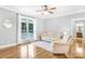 Sunlit living room showcasing hardwood floors and large window with a comfortable seating area at 132 Witherspoon Ln, Statesville, NC 28677