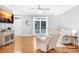 Bright living room featuring hardwood floors, a ceiling fan, a large window, and comfortable seating at 132 Witherspoon Ln, Statesville, NC 28677